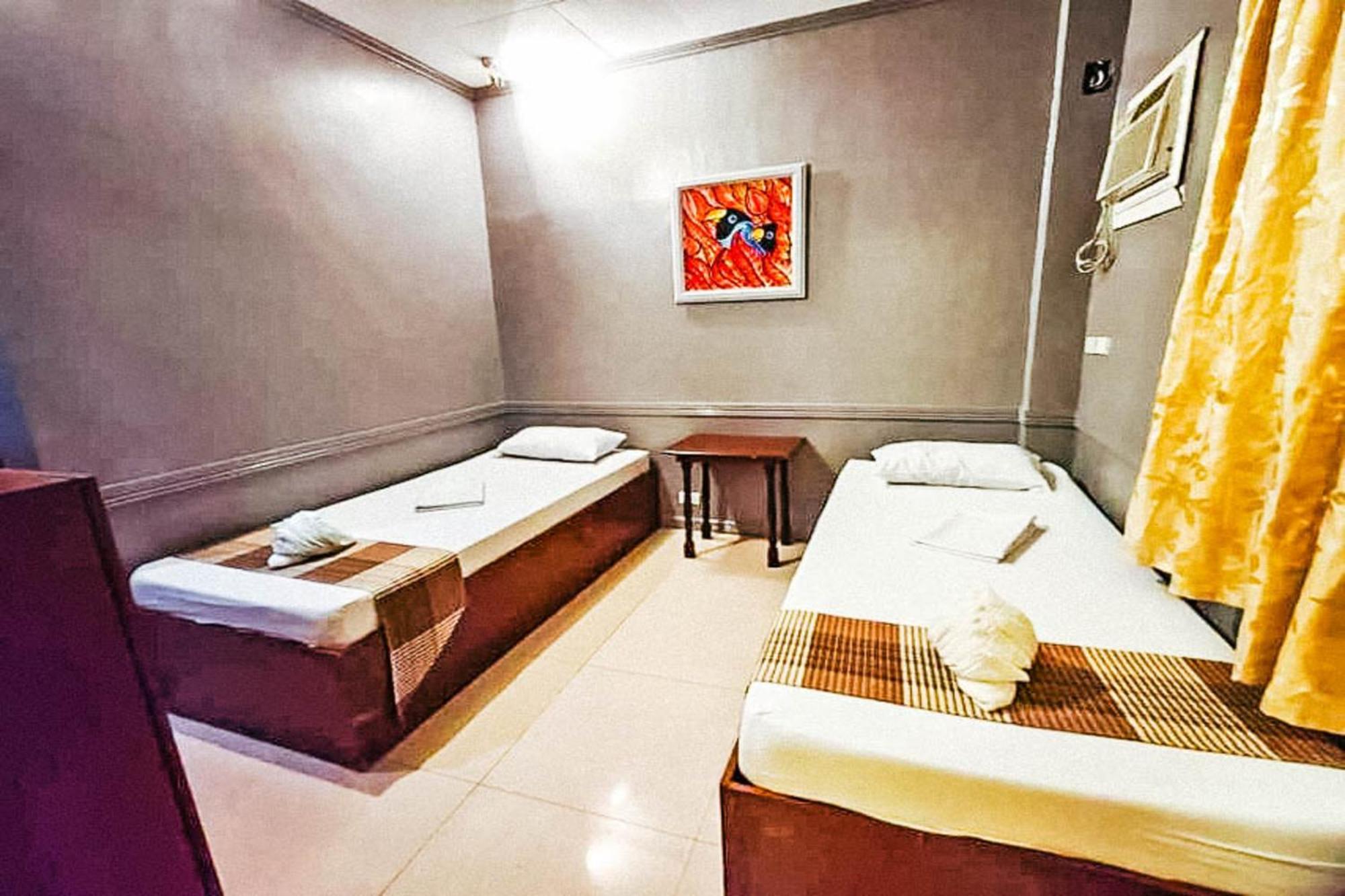 Mbg Travellers Inn Powered By Cocotel Puerto Princesa Szoba fotó