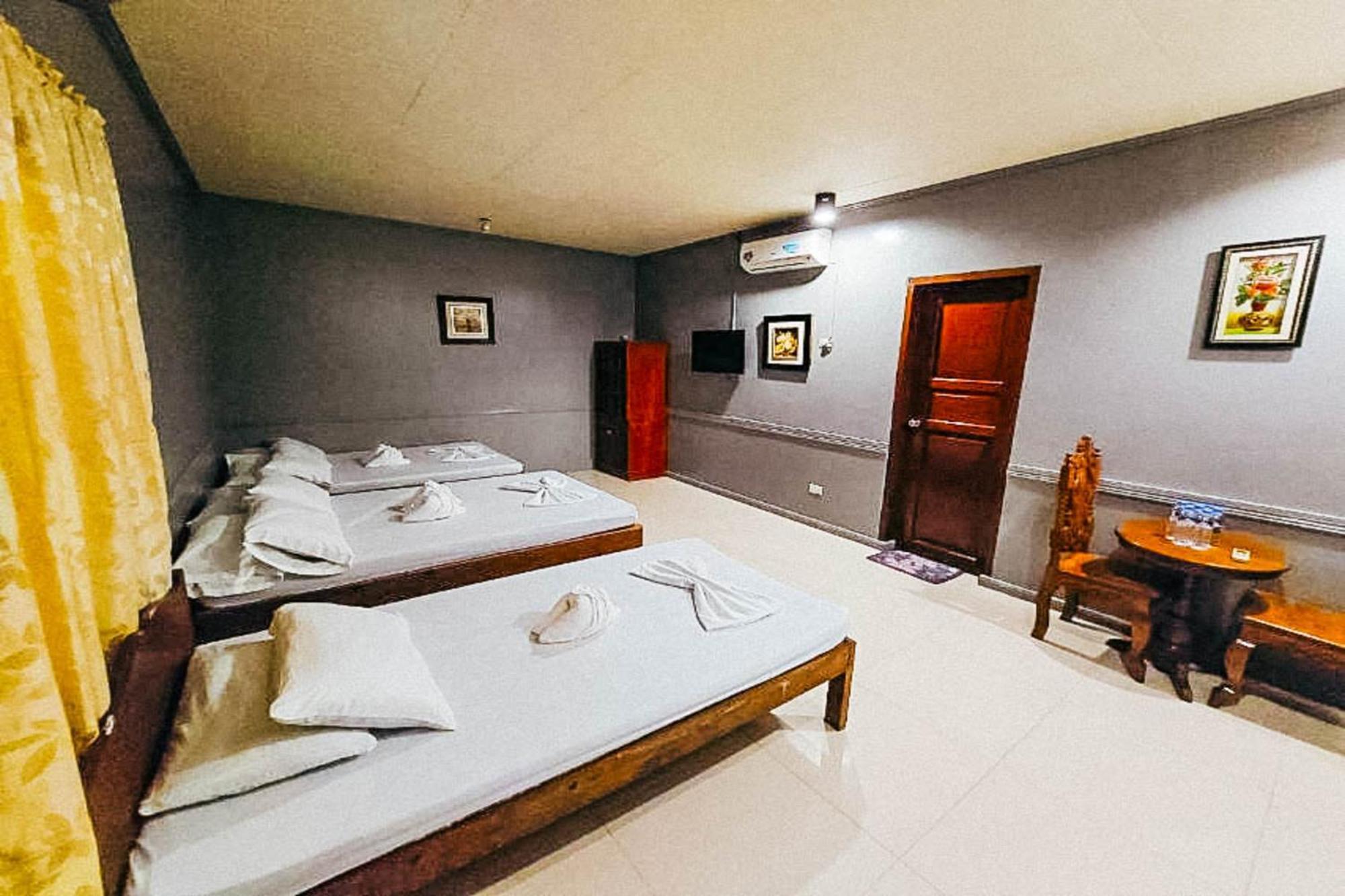 Mbg Travellers Inn Powered By Cocotel Puerto Princesa Szoba fotó