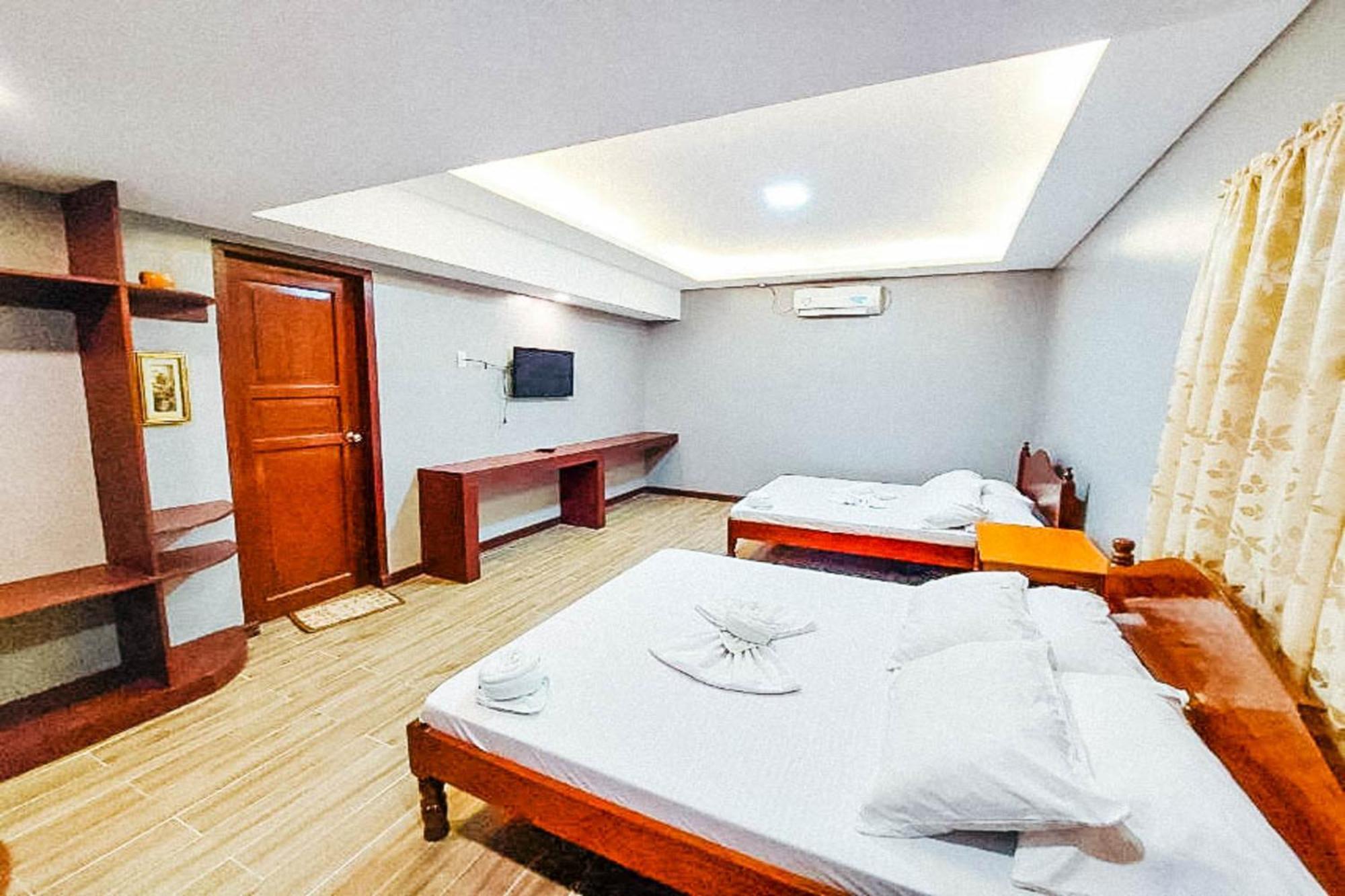 Mbg Travellers Inn Powered By Cocotel Puerto Princesa Szoba fotó