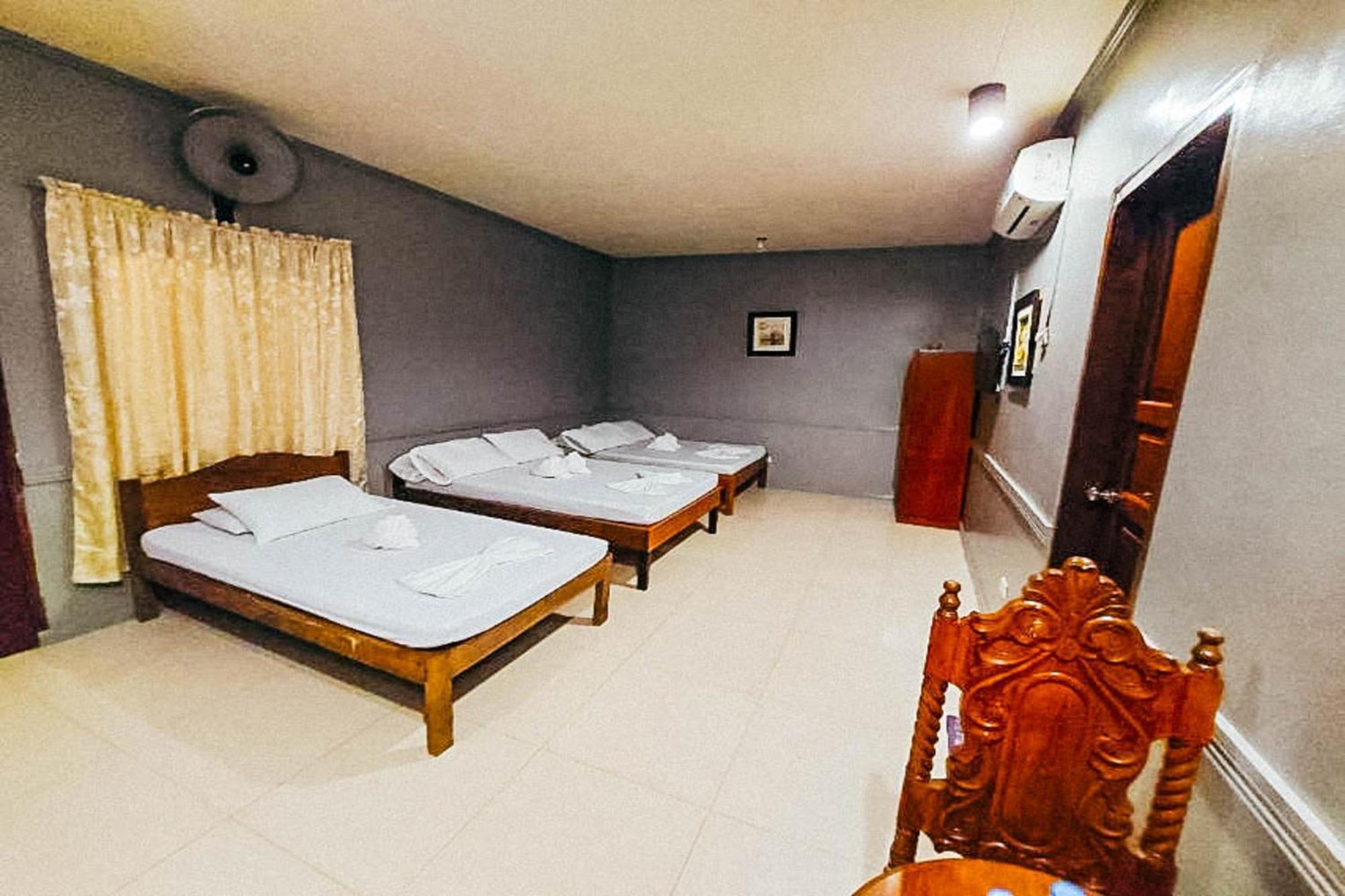Mbg Travellers Inn Powered By Cocotel Puerto Princesa Szoba fotó